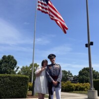 One very proud mom with her Riverside Military Academy graduate on Commencement Day. Mother and son under an American flag on Riverside Military Academy Commencement Day