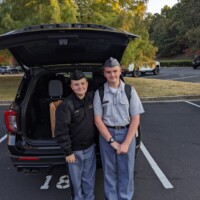 Back to Riverside after a weekend with Mom—with a trunk full of groceries, of course. Two Riverside Military Academy cadets in uniform returning to school with groceries after a weekend visit